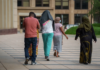 Somali Americans Welfare Fraud Scandal Shakes Minnesota: Gov. Tim Walz, Rep Ilhan Omar Face Mounting Political Pressure Feeding Our Future's then-Executive Director, Aimee Bock (center), leaves the federal courthouse in downtown Minneapolis